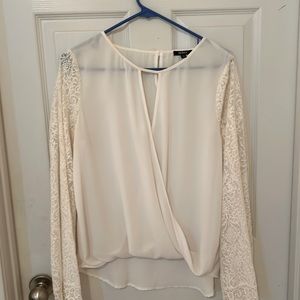 Graceful white blouse with lace sleeves